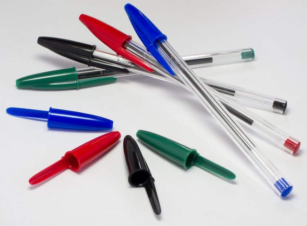 Red, black, green, and blue ballpoint pens.