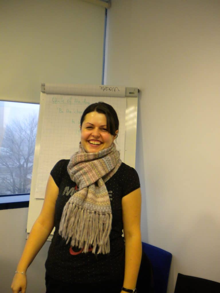 Rebeca Duriga wearing a scarf in front of a flipchart.