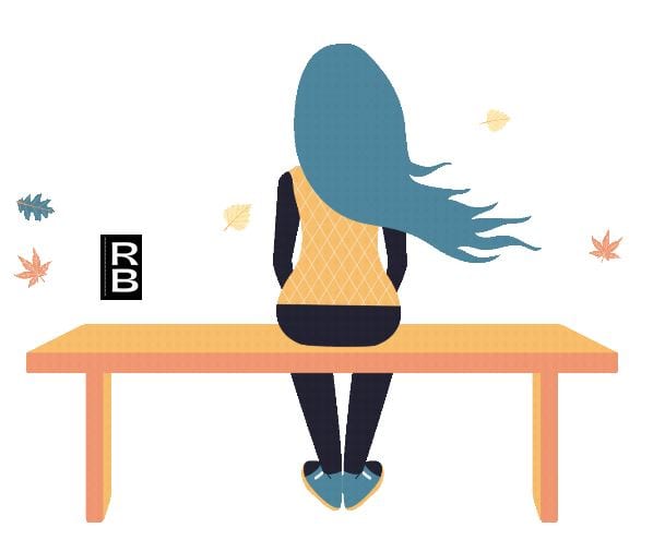 A girl with blue hair sitting alone on a bench.