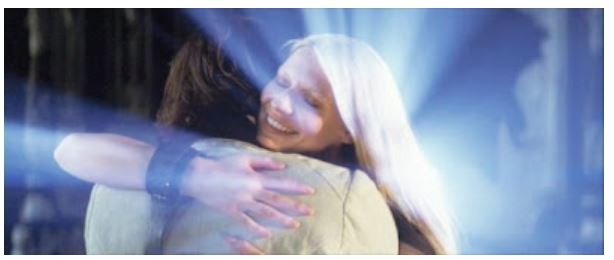The main characters of "Stardust" in a hug, with the female protagonist shining.